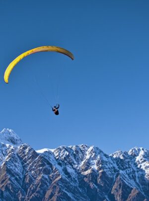 man on parachute near the mountain