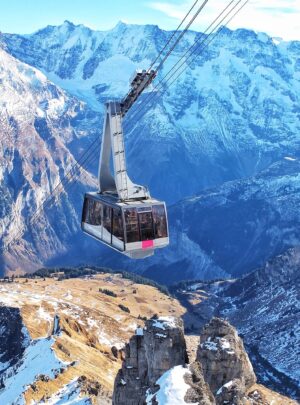 bird's eye view of ski lift over mountains during winter