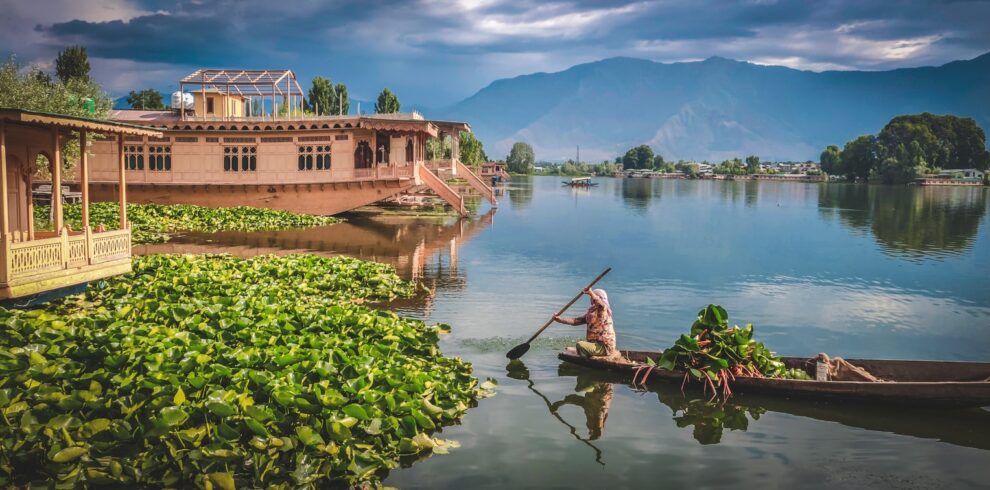 man in red shirt riding on brown boat on lake during daytime